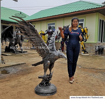 Eagle sculpture statue catching a salmon fish - life size metal animal art from Thailand