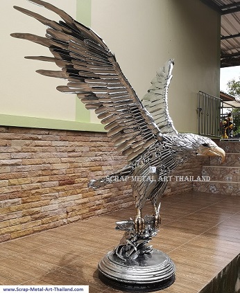 Eagle sculpture statue catching a salmon fish - life size scrap metal animal art from Thailand